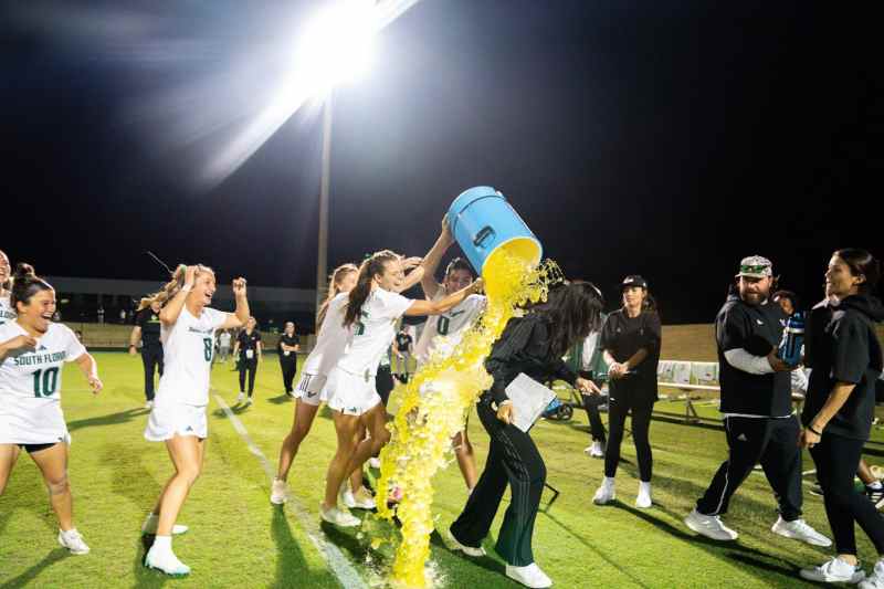 (Photo/USF Athletics) Players give Coach McCord a Gatorade bath after the program's first-ever win.